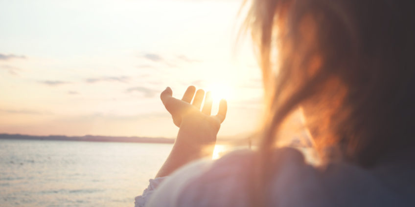 woman try to grab the sun